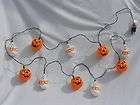 halloween lights orange plastic grinning pumpkins and ghosts that say 