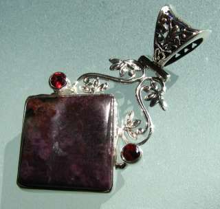 This is a beautiful solid silver pendant with plume agate, cut garnet 
