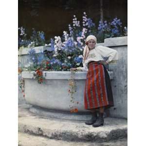 Gardener for Romanias Queen Poses by the Flowers at Bran Castle 