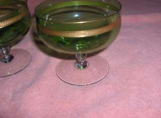 Up for sale are 2 beautiful vintage green crystal stemmed champagne 