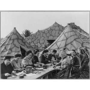  Women buttering bread in front of tents, Germany