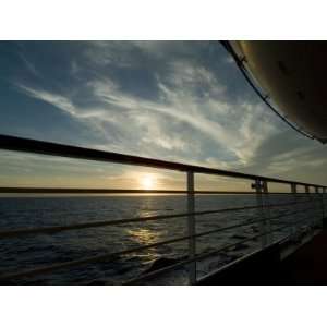 Looking at Sunset Through the Railing on the Deck of a Cruise Ship 