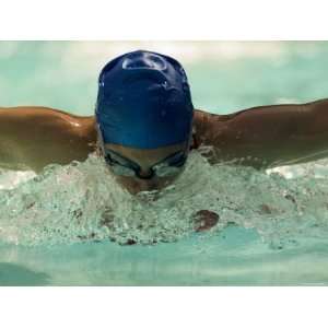  Young Woman Swimming the Butterfly Stroke in a Swimming Pool 