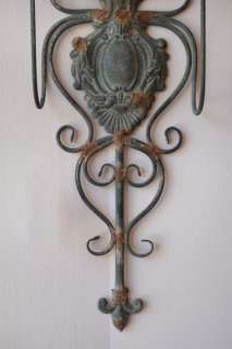 This gorgeous wall sconce is made of metal and has a rust like 